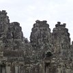 P007 The Bayon's most distinctive feature is the multitude of serene and massive stone faces on the many towers which jut out from the upper terrace and cluster...