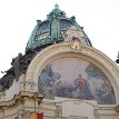 P006-015 A close up of the main cupola and the semi­circular colorful mosaic decorations adorned with a golden sign ”Hail to you Prague! Brave the time and malice as you...