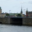 P017a Stadhusbron (City Hall Bridge) stretching over Klara sjö, with zoom-in view of Gamla Stan landmark buildings in background - (from left) - tower of Stockholms...